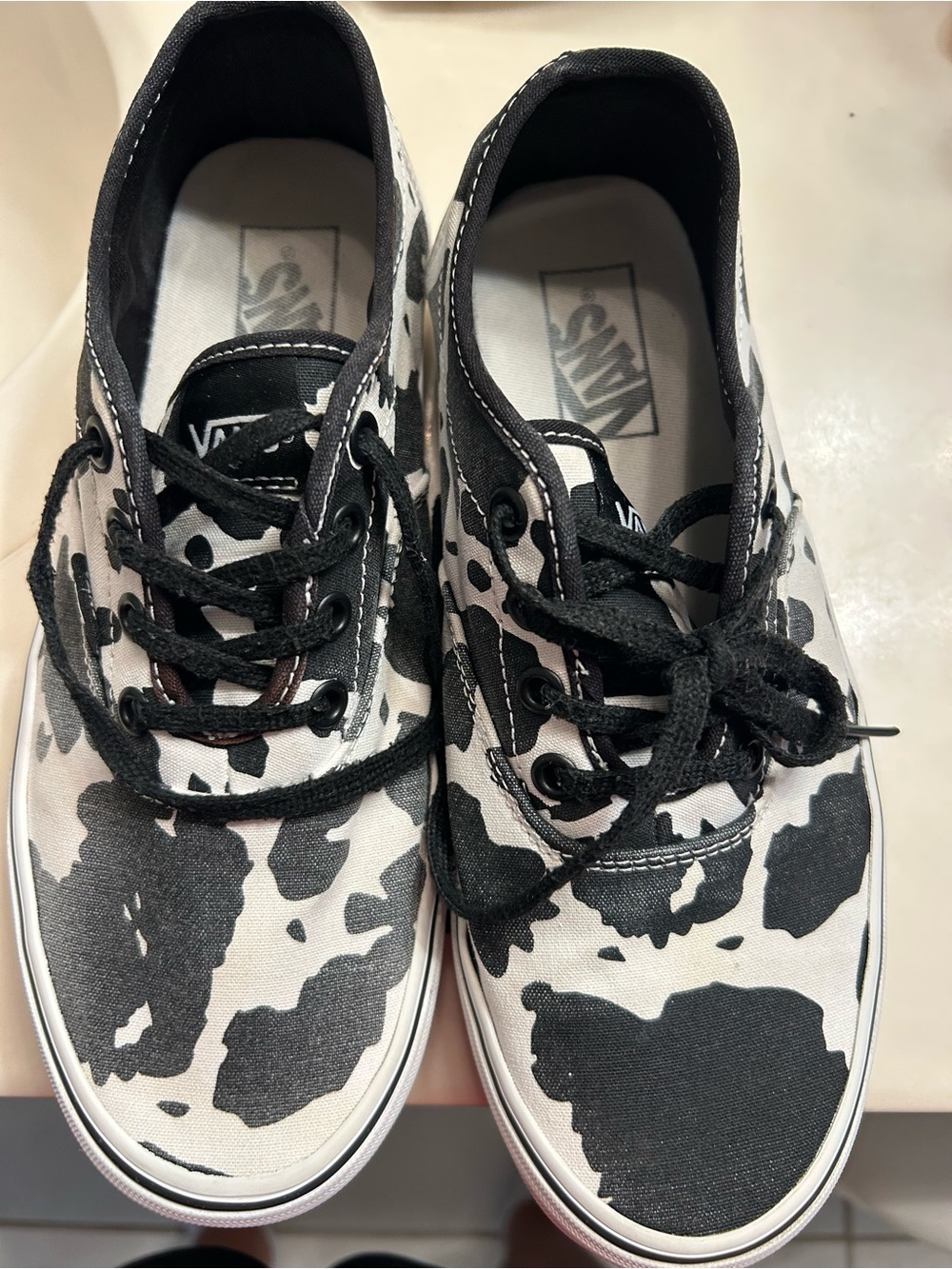 Women’s Vans Canvas Sneakers in Black and White Cow Print